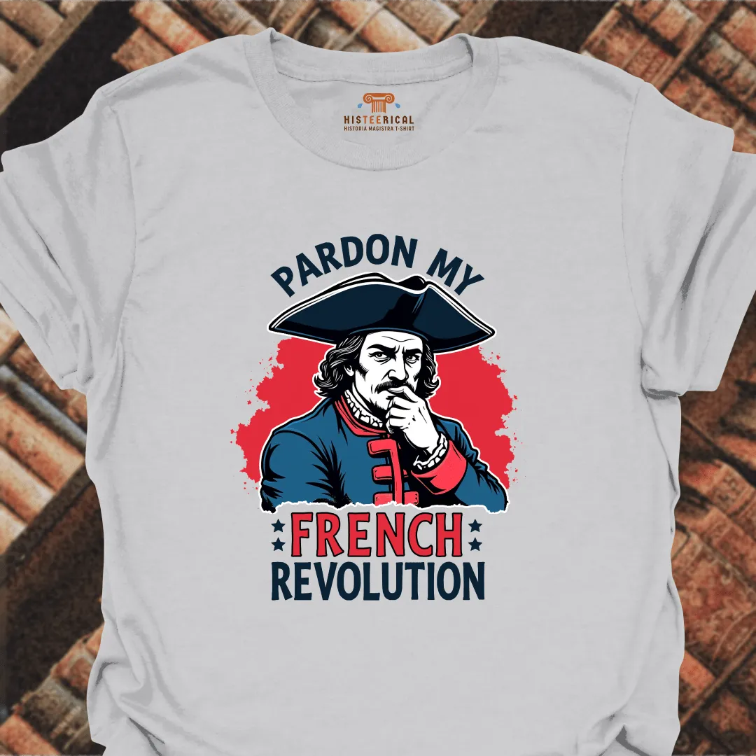 Grey t-shirt with a graphic of a historical figure and text 'Pardon My French Revolution' on a brick background.